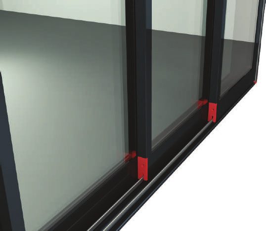 Détail des profils fins et du rail bas du mur de verre coulissant
